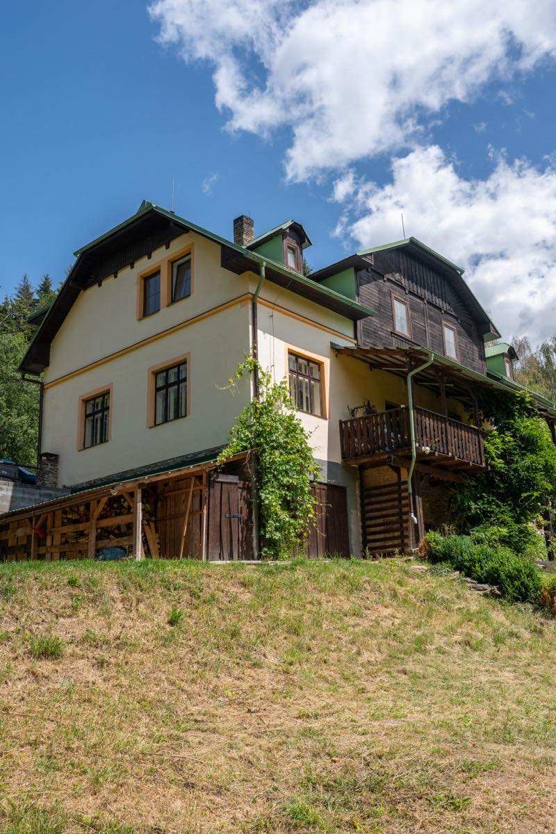 Boční pohled na celou budovu penzionu HamrákOFF s dřevěnou verandou